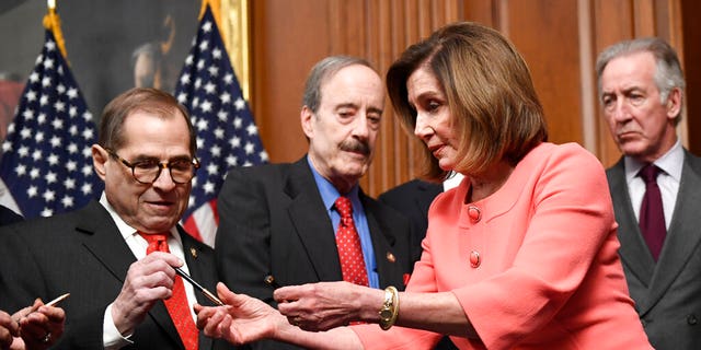 House Speaker Nancy Pelosi of Calif., second from right, gives pens to fellow Democrats after she signed the resolution to transmit the two articles of impeachment against President Donald Trump to the Senate for trial on Capitol Hill in Washington, Wednesday, Jan. 15, 2020. (Associated Press)