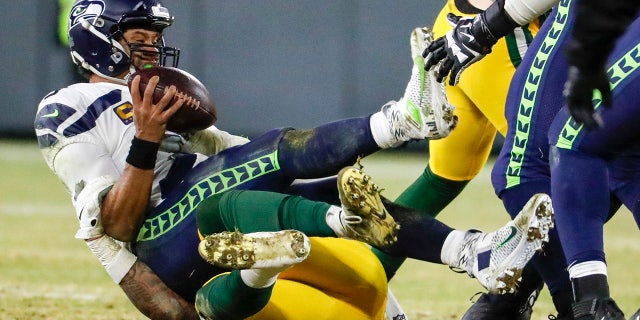Green Bay Packers' Preston Smith sacks Seattle Seahawks' Russell Wilson during the second half of an NFL divisional playoff football game Sunday, Jan. 12, 2020, in Green Bay, Wis. (AP Photo/Matt Ludtke)