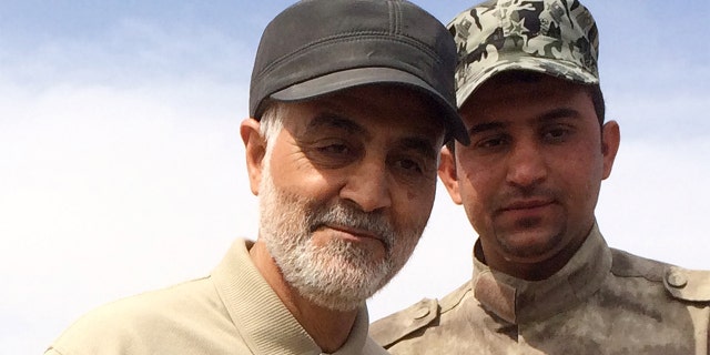 Iranian Revolutionary Guard Commander Qassem Soleimani (L) stands at the frontline during offensive operations against Islamic State militants in the town of Tal Ksaiba in Salahuddin province March 8, 2015. Picture taken March 8, 2015. REUTERS/Stringer