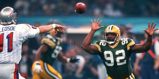 Drew Bledsoe #11 of the New England Patriots throws a pass while under pressure from Reggie White #92 of the Green Bay Packers during Super Bowl XXXI January 26, 1997 at the Louisiana Superdome in New Orleans, Louisiana . The Packers won the game 35-21. (Photo by Focus on Sport/Getty Images)