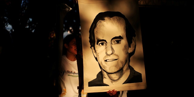 Students hold a portrait of Jesuit priest Ignacio Ellacuria prior to a procession commemorating the 28th anniversary of the murder of six Jesuit priests and two employees, at the Central American University (UCA) in San Salvador, El Salvador, on Nov. 11, 2017. REUTERS/Jose Cabezas/File