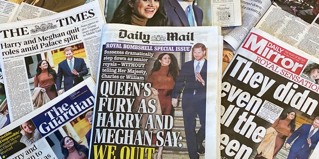 An arrangement of UK daily newspapers photographed in London shows front page headlines reporting on the news that Britain's Prince Harry and his wife Meghan plan to step back as "senior" members of the Royal Family. Charles. (Getty Images)