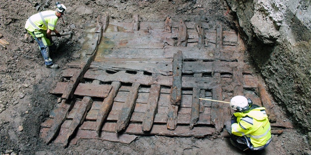 Archaeologists examine the wreck.