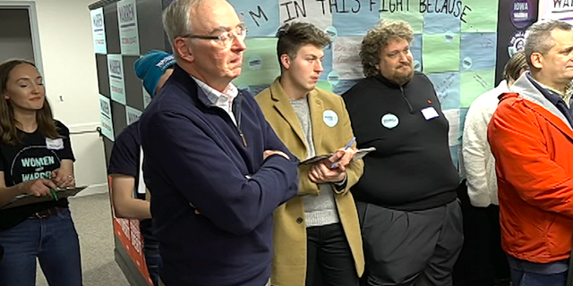 Sen. Elizabeth Warren's husband, Bruce Mann, celebrates the opening of a Warren for Iowa field office opening in Ankeny.