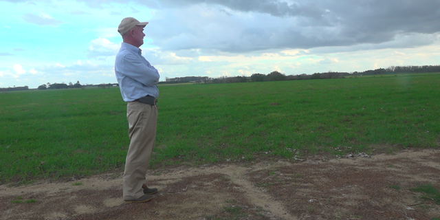 Farmer Murray Campbell stands on his farm, which pumps about 8-10 inches of water per acre in a growing season.