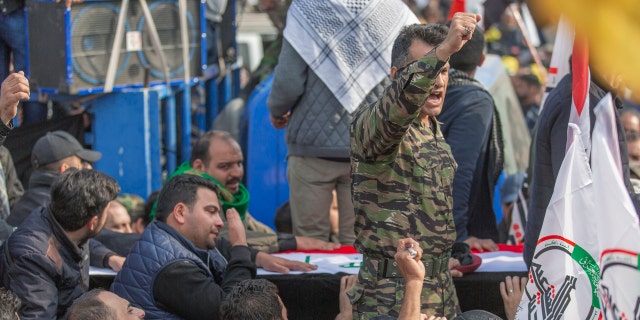 Mourners chant anti U.S. slogans during the funeral of Iran's top general Qassem Soleimani and Abu Mahdi al-Muhandis, deputy commander of Iran-backed militias in Iraq known as the Popular Mobilization Forces, in Baghdad, Iraq, Saturday, Jan. 4, 2020. (AP Photo/Nasser Nasser)