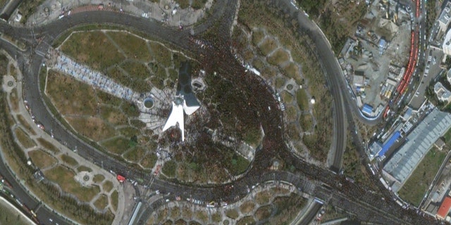 Crowds throng Tehran's Azadi square for the funeral of Revolutionary Guard Gen. Qassem Soleimani. (Satellite image ©2020 Maxar Technologies)