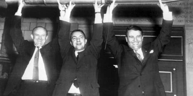 William Picketing, James Van Allen, and German scientist Wernher von Braun (from L to R) brandish a model of the first American satellite "Explorer 1", 31 January 1958 after the satellite was launched of by a "Jupiter C" rocket at Cap Canaveral Space Center. (Photo credit should read OFF/AFP/Getty Images)