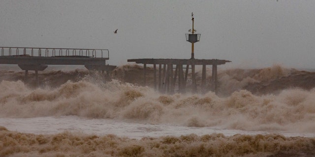 Massive waves and gale-force winds smashed into seafront towns, damaging many shops and restaurants and flooding some streets.