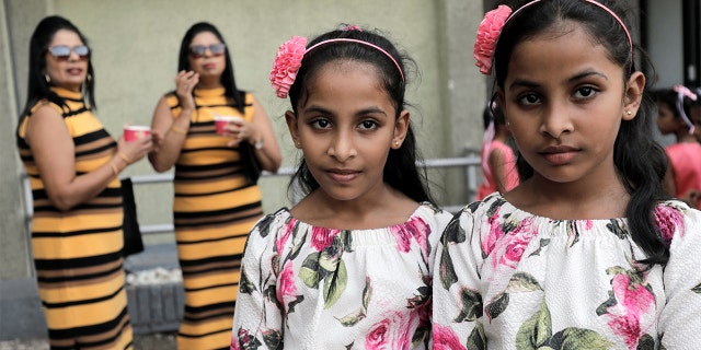 Twins pose for photographs during an event to attempt to break the world record for the biggest gathering of twins in Colombo, Sri Lanka.<br>
(REUTERS/Dinuka Liyanawatte)