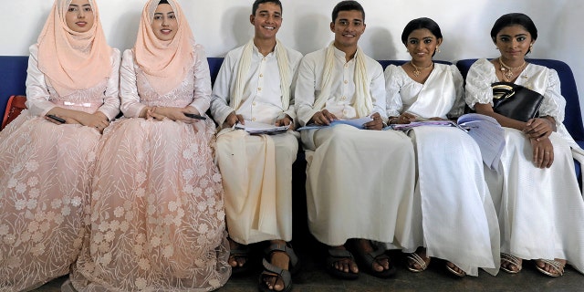 Twins pose for photographs during an event to attempt to break the world record for the biggest gathering of twins in Sri Lanka on Monday. (REUTERS/Dinuka Liyanawatte)