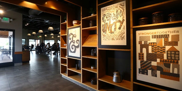 This Wednesday photo shows a Starbucks Community Store, which offers more space for patrons and a community meeting space, in Phoenix. (AP Photo/Ross D. Franklin)