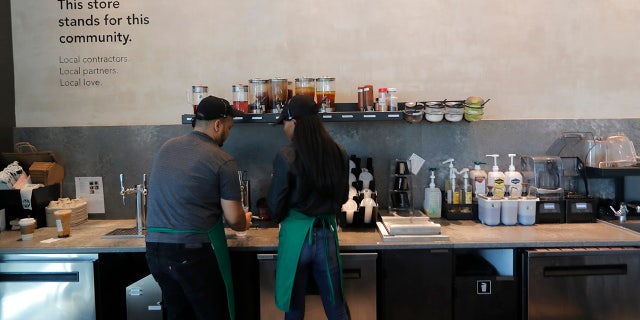 Baristas prepare drinks at a Starbucks on South Claiborne Ave. in New Orleans, Thursday. (AP Photo/Gerald Herbert)