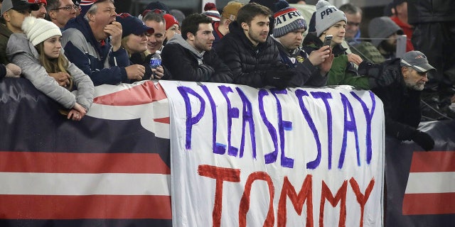 New England Patriots fans stand by a sign supporting quarterback Tom Brady in the first half of an NFL wild-card playoff football game between the Patriots and the Tennessee Titans, Saturday, Jan. 4, 2020, in Foxborough, Mass. Brady's contract expires at the end of the season. (AP Photo/Elise Amendola)