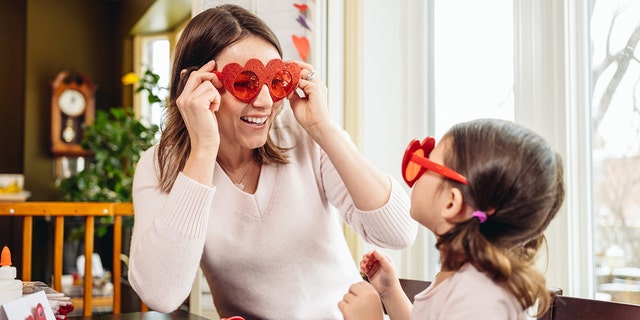 A mom and her young daughter are shown making greeting cards and having some one-on-one fun time ahead of Valentine's Day. 