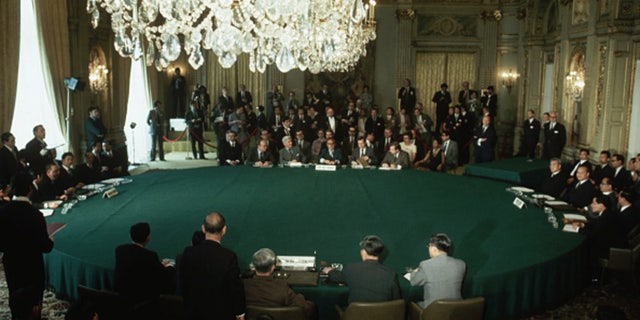 Representatives from the four factions of the Vietnam War meet in Paris to sign a peace agreement.