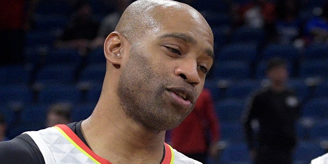 Atlanta Hawks guard Vince Carter (15) congratulates guard Brandon Goodwin (0) after an NBA basketball game against the Orlando Magic, Monday, Dec. 30, 2019, in Orlando, Fla. (AP Photo/Phelan M. Ebenhack)