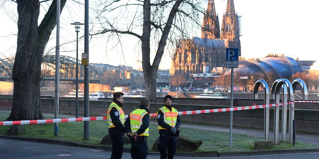 Employees of the public order office blocked a road close to the Cologne Cathedral on Tuesday as experts defused a World War II-era bomb. (Roberto Pfeil/dpa via AP)