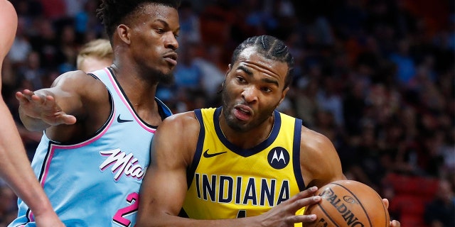Indiana Pacers forward T.J. Warren (1) drives against Miami Heat forward Jimmy Butler (22) during the first half of an NBA basketball game Friday, Dec. 27, 2019, in Miami. (AP Photo/Wilfredo Lee)