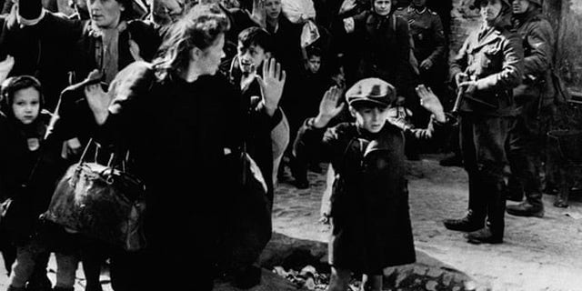 Frightened Jewish families surrender to Nazi soldiers at the Warsaw Ghetto in 1943. In January of that year, the residents of the ghetto rose against the Nazis and held their ground for several months, but were defeated after fierce fighting in April and May