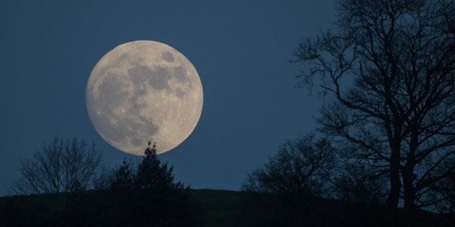 A so-called wolf Moon rises over Glastonbury Tor on January 11, 2017 in Somerset, England - file photo.