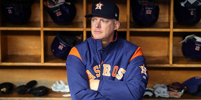 Manager AJ Hinch #14 of the Houston Astros looks on from the dugout prior to Game 5 of the ALCS between the Houston Astros and the New York Yankees at Yankee Stadium on Friday, October 18, 2019 in the Bronx borough of New York City. (Photo by Alex Trautwig/MLB Photos via Getty Images)