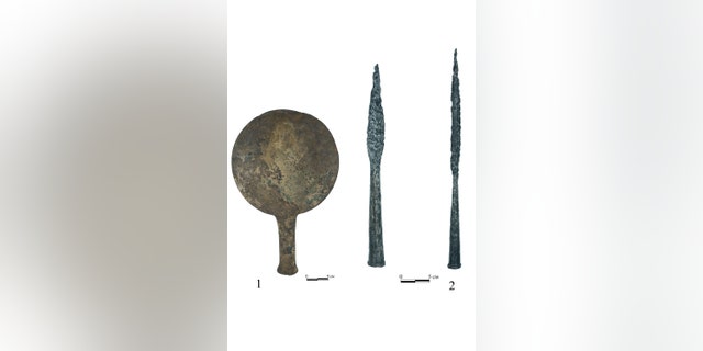 Bronze mirror and iron spear heads from the burial. (Credit: Institute of Archaeology RAS)