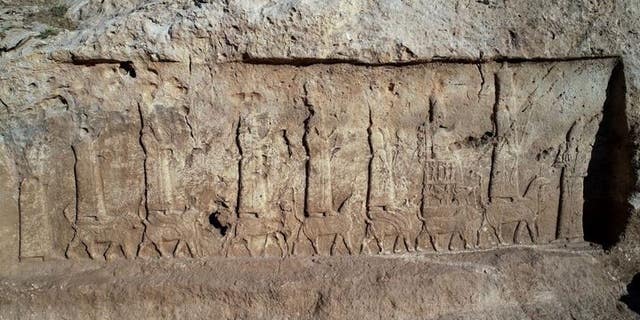 The unearthed panels show a procession of the seven main Assyrian gods and goddesses, standing or seated on mythical animals, and the Assyrian king Sargon II.