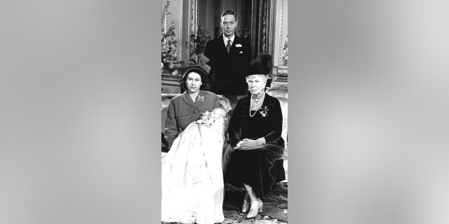Queen Elizabeth pictured with her first son, Prince Charles, her grandmother Queen Mary and father King George VI at Buckingham Palace on the day of his Christening.
