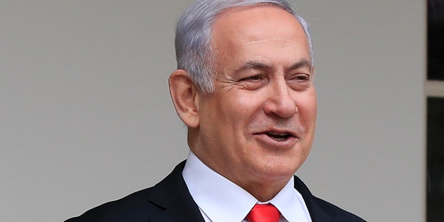 FILE - In this March 25, 2019, file photo, President Donald Trump welcomes visiting Israeli Prime Minister Benjamin Netanyahu to the White House in Washington. A blueprint the White House is rolling out to resolve the decades-long conflict between the Israelis and Palestinians is as much about politics as it is about peace. President Donald Trump said he would likely release his long-awaited Mideast peace plan a little before he meets Tuesday with Israeli Prime Minister Benjamin Netanyahu and his main political rival Benny Gantz. (AP Photo/Manuel Balce Ceneta, File)