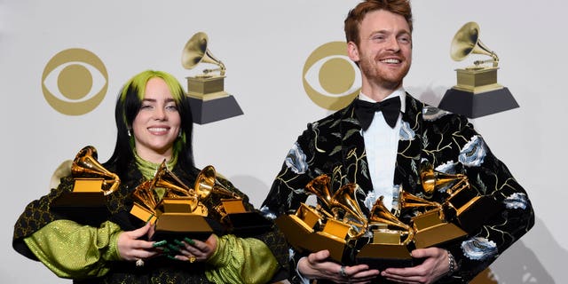 Billie Eilish, left, and Finneas O'Connell pose in the press room with the awards for best album, best engineered album and best pop vocal album for "We All Fall Asleep, Where Do We Go?," best song and record for "Bad Guy," best new artist and best producer, non-classical at the 62nd annual Grammy Awards at the Staples Center on Sunday, Jan. 26, 2020, in Los Angeles.