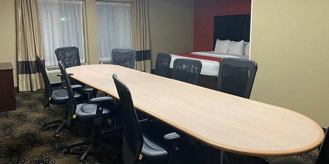The “boardroom suite” came complete with a literal boardroom table and nine swivel chairs, as well as a queen-sized bed tucked into an alcove in the corner.<br>