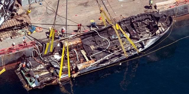 FILE - In this Sept. 12, 2019, file photo, the burned hull of the Conception is brought to the surface by a salvage team off Santa Cruz Island in the Santa Barbara Channel in Southern California. (Brian van der Brug/Los Angeles Times via AP, File)