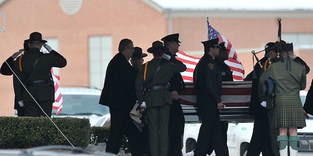 In this 2010 file photo, law enforcement officers carry the casket of Border Patrol officer and former U.S. Marine Brian Terry out of Greater Grace Temple after his funeral service in Detroit, Mich.