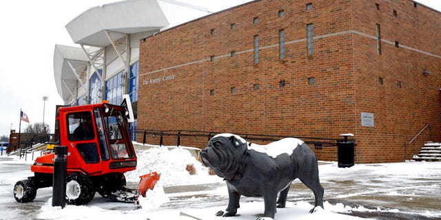 A statue depicting Drake University's bulldog mascot stands outside a university venue that will host a Democratic presidential primary as workers clear snow, Monday, Jan. 13, 2020, in Des Moines, Iowa. The debate is scheduled for Tuesday. (AP Photo/Patrick Semansky)