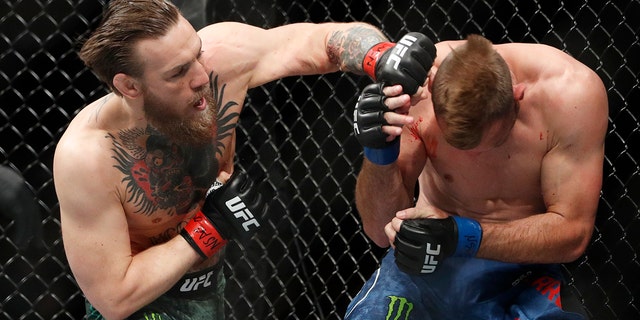 Conor McGregor hits Donald "Cowboy" Cerrone during a UFC 246 welterweight mixed martial arts bout Saturday, Jan. 18, 2020, in Las Vegas. (Associated Press)