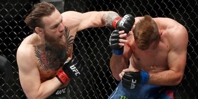 Conor McGregor hits Donald "Cowboy" Cerrone during a UFC 246 welterweight mixed martial arts bout Saturday, Jan. 18, 2020, in Las Vegas. (Associated Press)