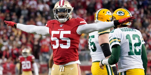 San Francisco 49ers defensive end Dee Ford (55) gestures next to Green Bay Packers quarterback Aaron Rodgers (12) during the first half of the NFL NFC Championship football game Sunday, Jan. 19, 2020, in Santa Clara, Calif. (AP Photo/Tony Avelar)