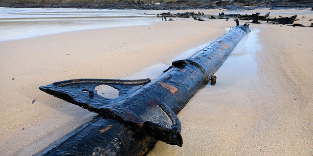 102 years after it declared a total loss, the metal ribs of the 60ft steel-hulled SV Carl began emerging from the sand just before Christmas. (Credit: SWNS)