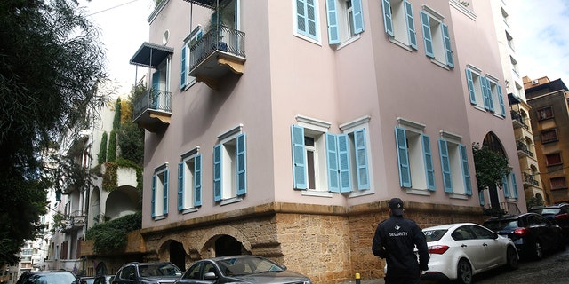 A private security guard stood outside the house of ex-Nissan chief Carlos Ghosn in Beirut, Lebanon, on Sunday. (AP Photo/Hussein Malla)