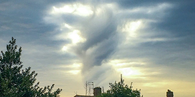 A strange cloud spotted by Caroline Hawthorne over her house in Birmingham which she says looks like a looming Jesus figure. (SWNS)