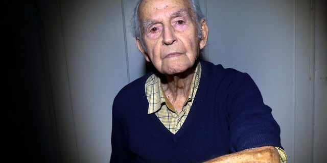 Holocaust and Auschwitz survivor Leon Schwarzbaum shows his tattooed identification number in his home in Berlin on Jan. 4, 2020. (AP Photo/Markus Schreiber)