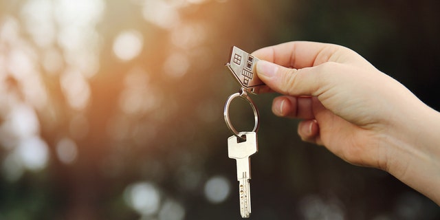 FILE - A person is seen holding a house key.