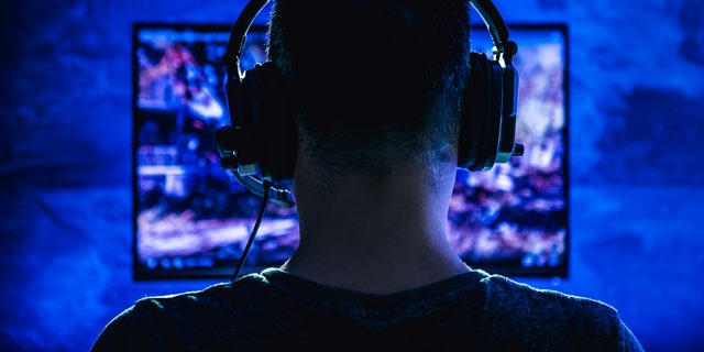 Person wearing headphones using computer.