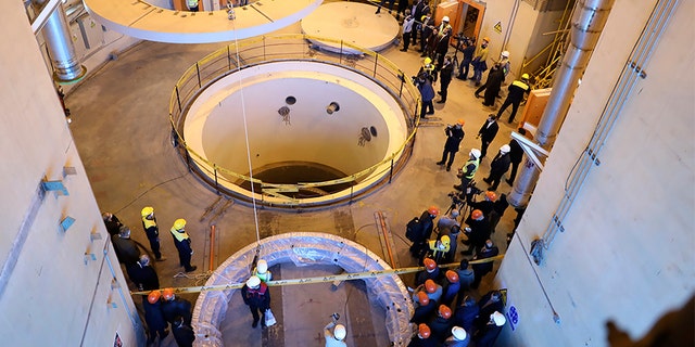 Technicians work at the Arak heavy water reactor's secondary circuit, as officials and media visit the nuclear site near Arak, Iran.