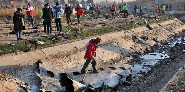 Rescue workers inspect the scene where a Ukrainian plane crashed in Shahedshahr, southwest of the capital Tehran, Iran, on Wednesday. (AP)