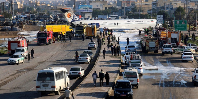An Iranian passenger plane sits on a road outside Mahshahr airport after skidding off the runway, in southwestern city of Mahshahr, Iran, Monday, Jan. 27, 2020.  (Mohammad Zarei/ISNA via AP)