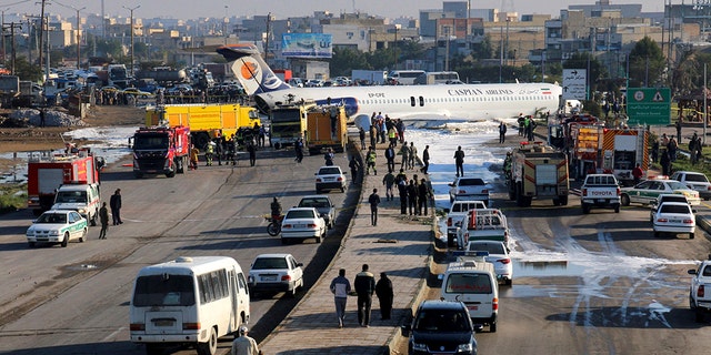 An Iranian passenger plane sits on a road outside Mahshahr airport after skidding off the runway, in southwestern city of Mahshahr, Iran, Monday, Jan. 27, 2020. (Mohammad Zarei/ISNA via AP)