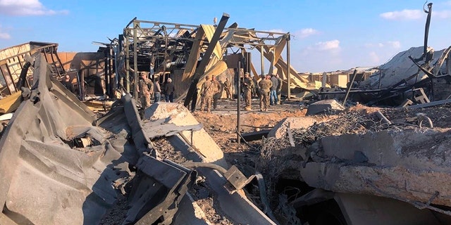 U.S. soldiers and journalists inspect the rubble at a site of Iranian bombing, in Ain al-Asad base in Anbar, Iraq, on Monday. (AP)