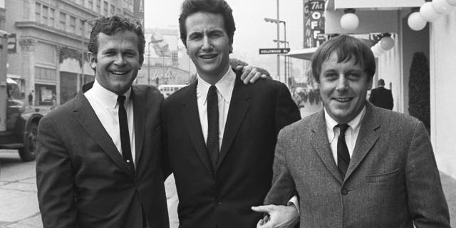 In this Jan. 31, 1967, file photo, members of the Kingston Trio, from left: Bob Shane, John Stewart and Nick Reynolds are pictured in the Hollywood section of Los Angeles. Shane, the last surviving original member of the popular folk group the Kingston Trio and the lead singer on its million-selling ballad “Tom Dooley” and many other hits, died Sunday, Jan. 26, 2020, in Phoenix. He was 85.